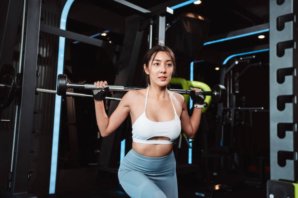 istock Woman working out Bodybuilder with barbell weights at the gym. bodybuilder doing exercises with barbell. training sport healthy lifestyle bodybuilding, Athlete builder muscles lifestyle. 1477870073