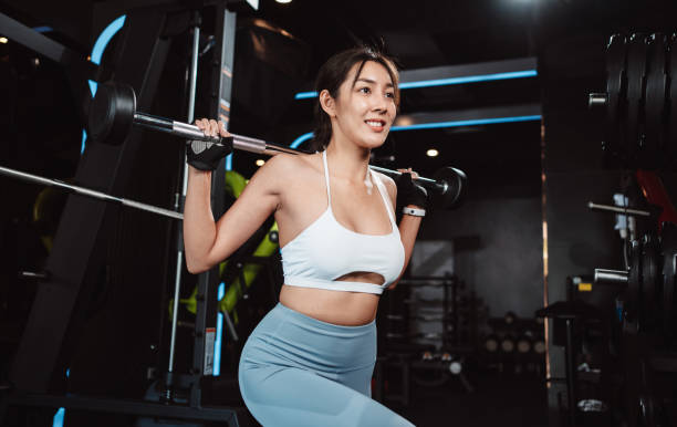 istock Woman working out Bodybuilder with barbell weights at the gym. bodybuilder doing exercises with barbell. training sport healthy lifestyle bodybuilding, Athlete builder muscles lifestyle. 1477870117