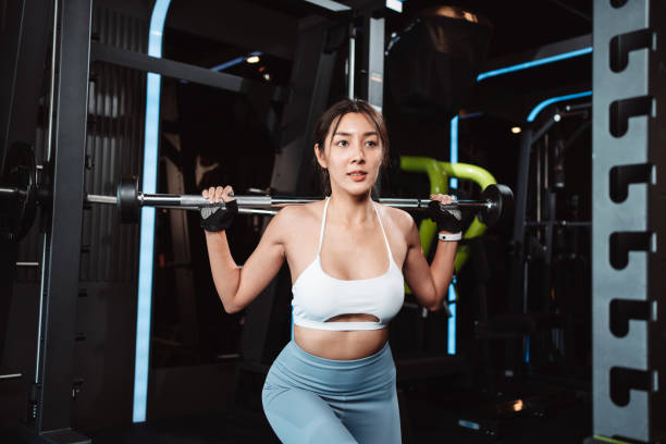 istock Woman working out Bodybuilder with barbell weights at the gym. bodybuilder doing exercises with barbell. training sport healthy lifestyle bodybuilding, Athlete builder muscles lifestyle. 1477870119