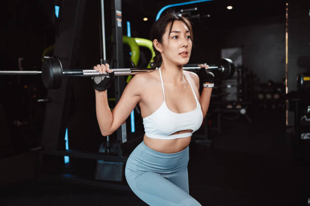 istock Woman working out Bodybuilder with barbell weights at the gym. bodybuilder doing exercises with barbell. training sport healthy lifestyle bodybuilding, Athlete builder muscles lifestyle. 1477870194