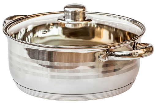 Studio shot of stainless steel Casserole with handles, covered with transparent glass lid, isolated on white background, side view.