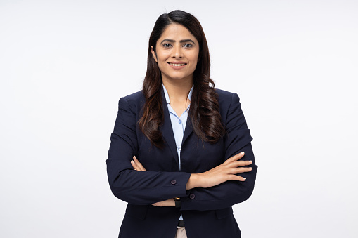 Portrait of happy young businesswoman arms crossed  with looking at camera on white background