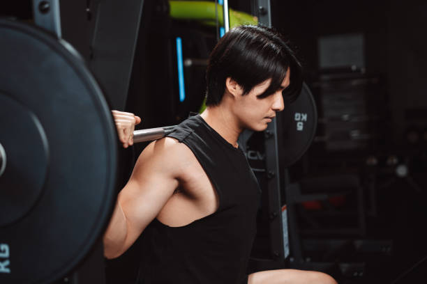 istock Man working out Bodybuilder with barbell weights at the gym. bodybuilder doing exercises with barbell. training sport healthy lifestyle bodybuilding, Athlete builder muscles lifestyle. 1477871456