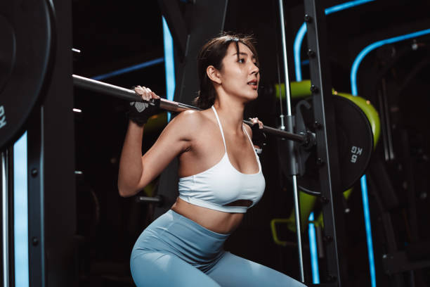 istock Woman working out Bodybuilder with barbell weights at the gym. bodybuilder doing exercises with barbell. training sport healthy lifestyle bodybuilding, Athlete builder muscles lifestyle. 1477871756