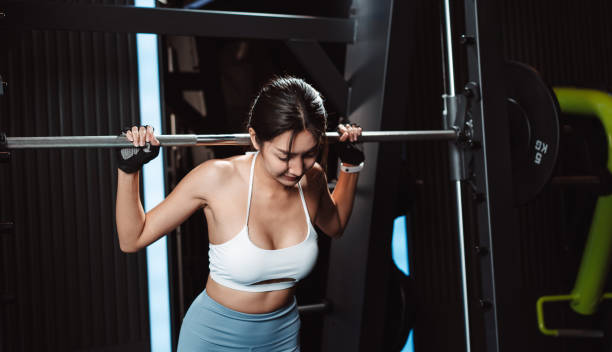istock Woman working out Bodybuilder with barbell weights at the gym. bodybuilder doing exercises with barbell. training sport healthy lifestyle bodybuilding, Athlete builder muscles lifestyle. 1477871791