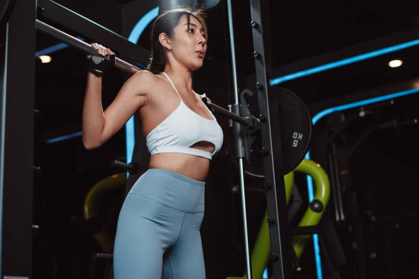 istock Woman working out Bodybuilder with barbell weights at the gym. bodybuilder doing exercises with barbell. training sport healthy lifestyle bodybuilding, Athlete builder muscles lifestyle. 1477871823