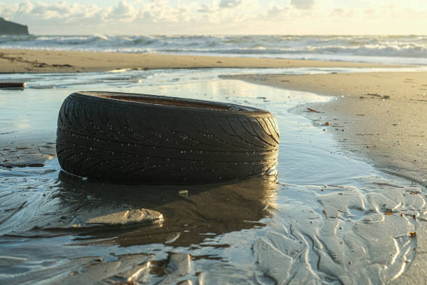 istock Used rubber car tyre discarded on sea ecosystem,environmental nature pollution 1477872892