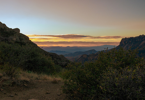 View of mountain landscape and beyond from The Window trail in Big Bend National Park in early morning near sunrise in January.