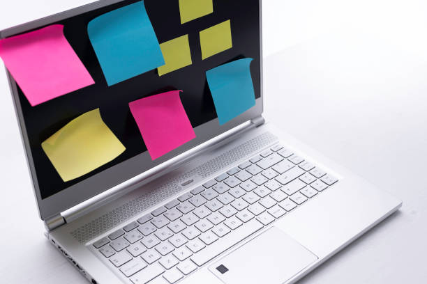 istock Color post it paper stick on screen of laptop 1477873236