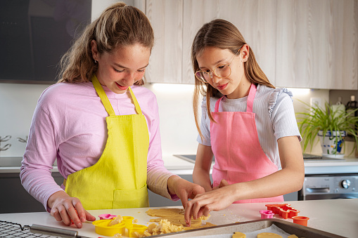 istock Two girls having fun making Easter cookies 1477873523