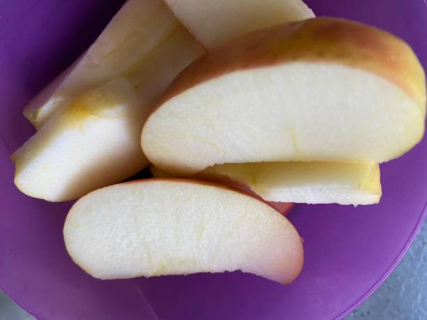 istock Apple wedges in a purple bowl 1477873526
