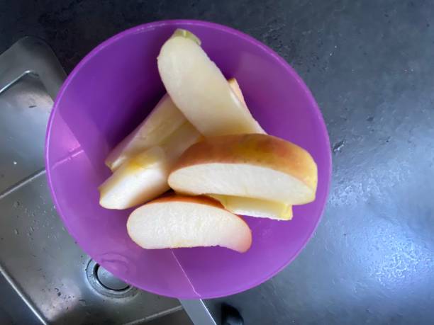 istock Apple wedges in a purple bowl 1477873661