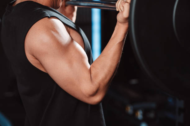istock Man working out Bodybuilder with barbell weights at the gym. bodybuilder doing exercises with barbell. training sport healthy lifestyle bodybuilding, Athlete builder muscles lifestyle. 1477873732