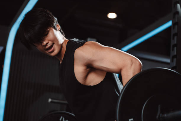 istock Man working out Bodybuilder with barbell weights at the gym. bodybuilder doing exercises with barbell. training sport healthy lifestyle bodybuilding, Athlete builder muscles lifestyle. 1477873774