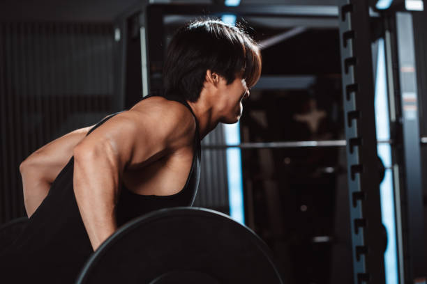 istock Man working out Bodybuilder with barbell weights at the gym. bodybuilder doing exercises with barbell. training sport healthy lifestyle bodybuilding, Athlete builder muscles lifestyle. 1477873787