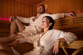 Mid adult couple enjoying time in sauna