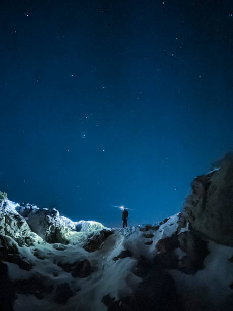 istock hiker exploring with headlamp on the mountain at night with starry sky 1477875375