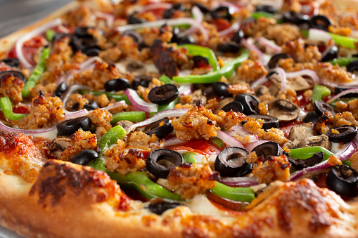 A closeup view of a supreme pizza.