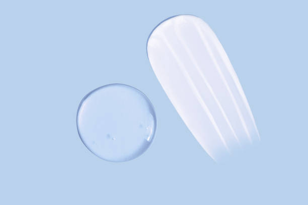 istock Cream smear texture and transparent gel smear texture on blue background 1477877044
