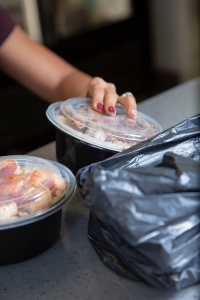 istock employee preps packed food 1477878451
