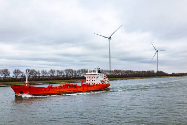 istock A tanker ship passing through a canal in the Netherlands with wind generators on the shore. 1477880682