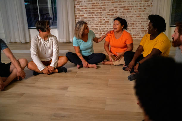 istock People sitting on the ground on a group therapy 1477880757