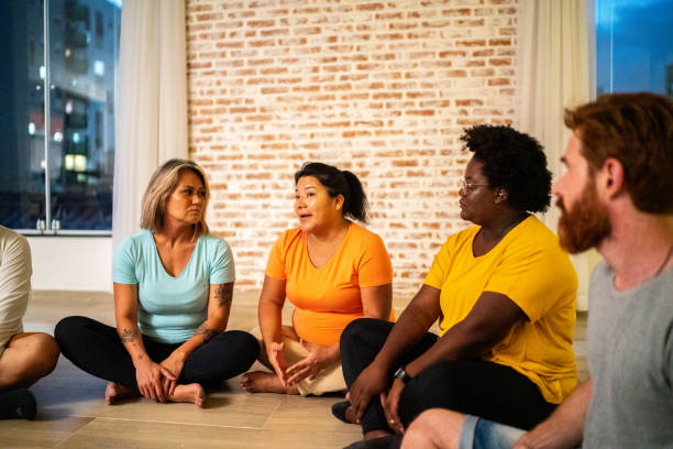 Mature woman talking in a group therapy