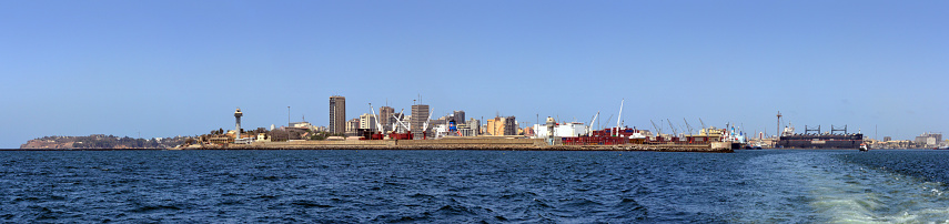 Dakar, Senegal: very high-resolution panorama of Dakar from the Atlantic ocean - the city center (Plateau district) and the port - the tallest building is the BCEAO headquarters (Central Bank of West African States) - Plateau district and port. Dakar is the country's most important economic center. The city is located on the Cape-Verde Peninsula, midway between the mouths of the Gambia and Sénégal rivers, with a large port on the Atlantic coast, protected by the limestone cliffs of the cape and by a system of breakwaters. Dakar is the westernmost city in continental Africa. The city's name originates in the Wolof word for the tamarind tree, 'dhakar'.