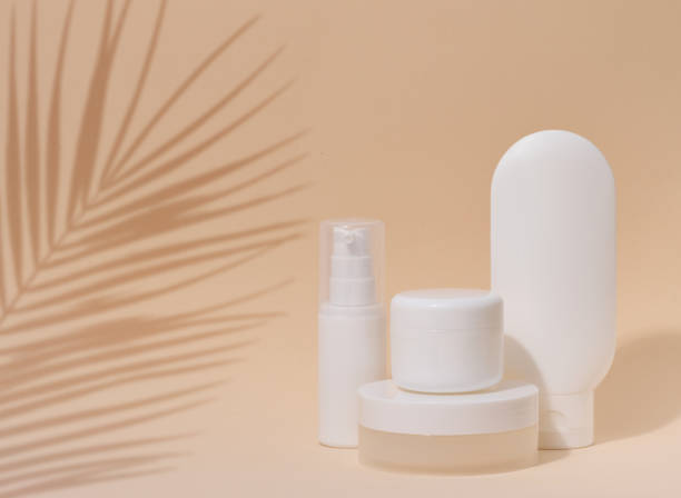 istock White plastic container tube, a jar with a lid for cosmetics on a beigebackground with a shadow from a palm leaf. Advertising and promotion 1477887787