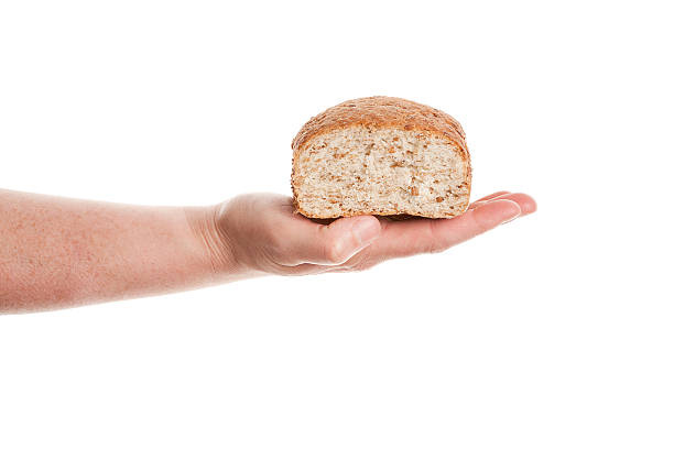 istock Hand keeping loaf of baked bread 147788890