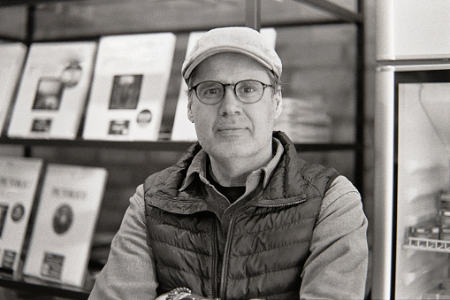 A black and white 35mm film scan of a middle aged man portrait.