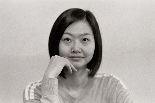 A black and white 35mm film scan of a Japanese woman portrait.