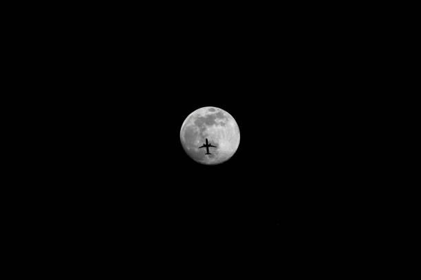 A Jet Flying Under a Full Moon at Night, Color Image