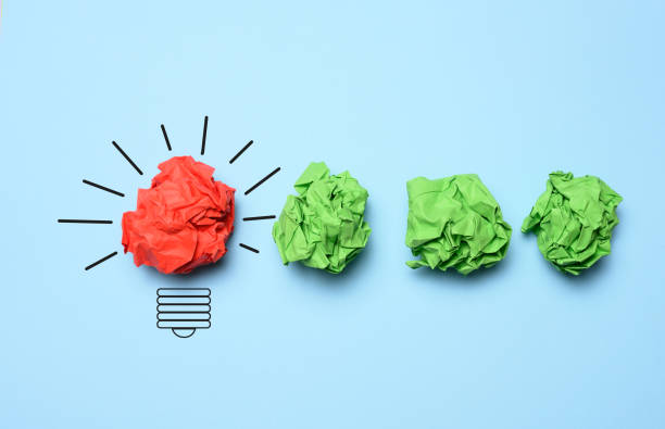 istock The concept of inspiration with new ideas, the search for creative solutions, crumpled sheets of paper in the form of balls on a blue background 1477896964
