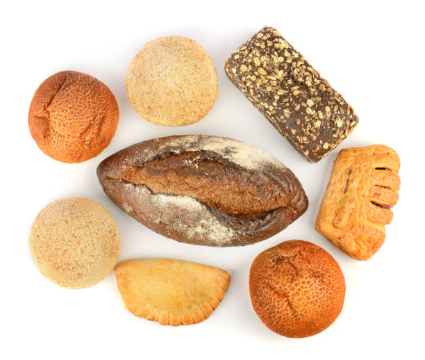 istock Beautiful baked bread and buns isolated on white. Top view. 1477897839