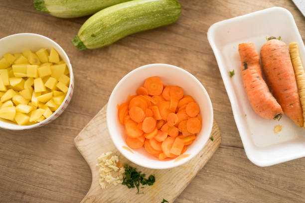 istock Vegetables on wooden table in kitchen. 1477900825