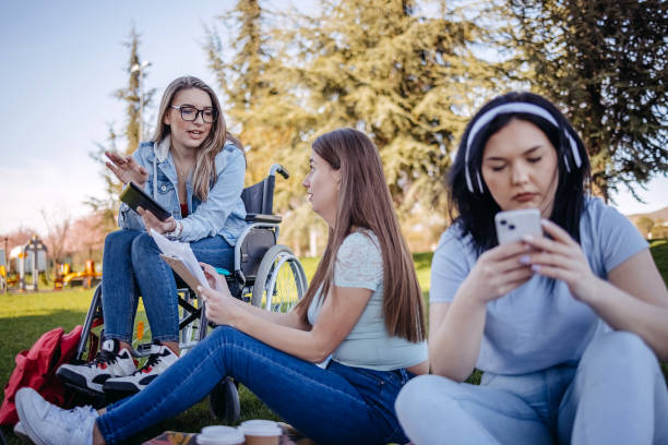 istock College student with disability spending time with friends outside and learning 1477901073