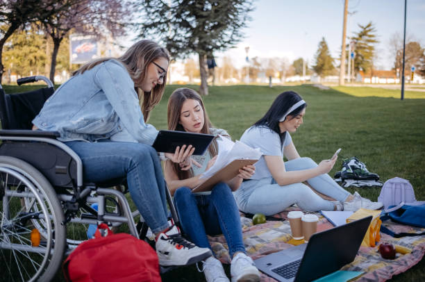 istock College student with disability spending time with friends outside and learning 1477901103