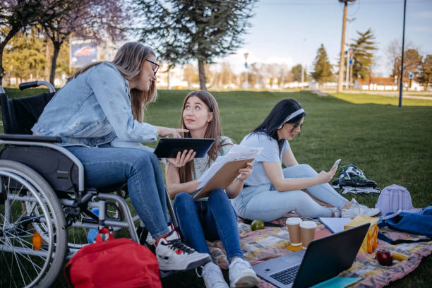 istock College student with disability spending time with friends outside and learning 1477901111