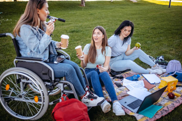 istock College student with disability spending time with friends outside and learning 1477901330