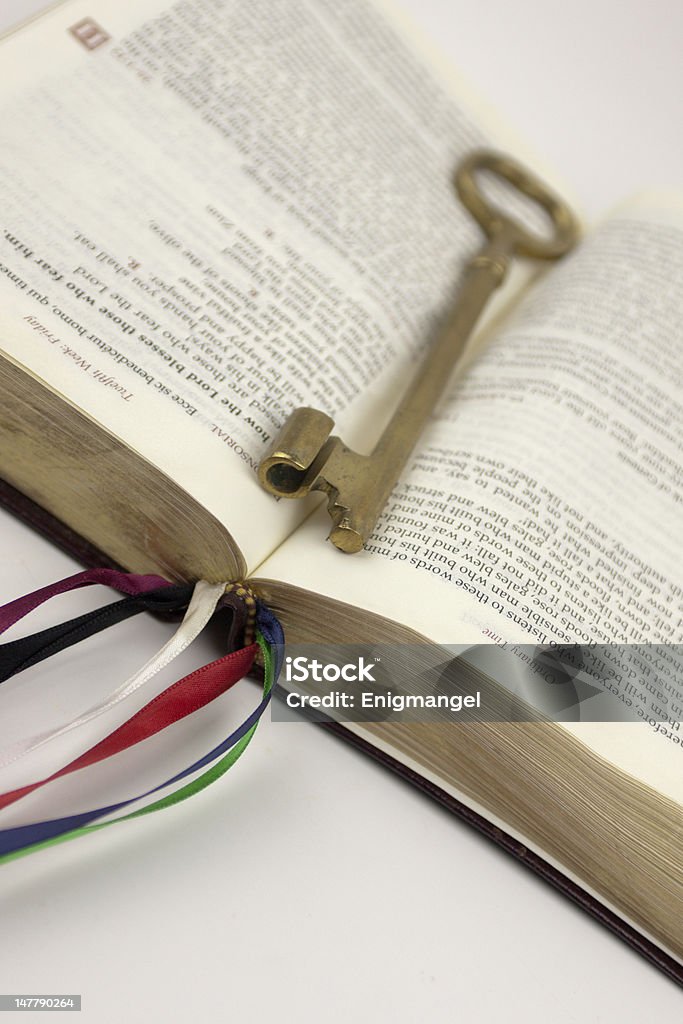 Book Marked With A Key Open book marked with a gold key Antique Stock Photo