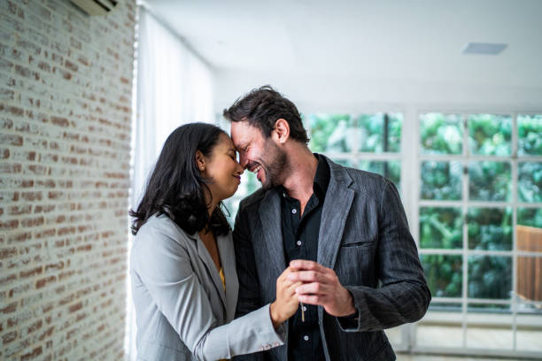 istock Couple holding house key at home 1477903052