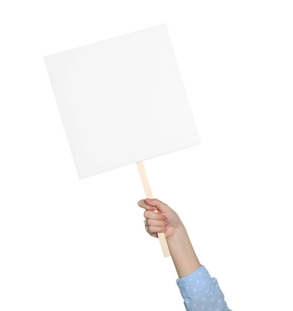 istock Woman holding blank protest sign on white background, closeup 1477905047