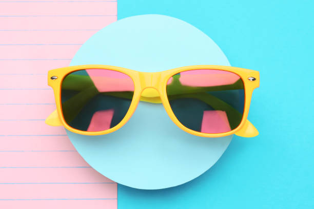 istock Stylish sunglasses on color background, top view 1477905064
