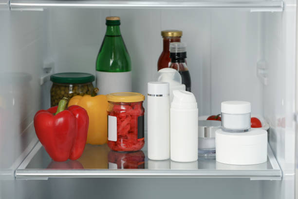 istock Different cosmetic products on shelf in refrigerator 1477906721