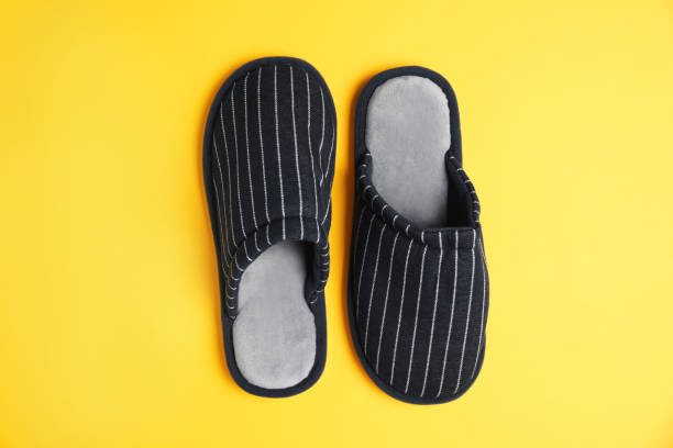 istock Pair of stylish slippers on yellow background, top view 1477906743