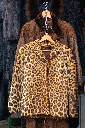 Real fur female coat with leopard print sold on outdoors market