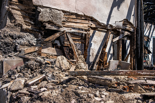 Burned, abandoned house, decaying crumbling walls.