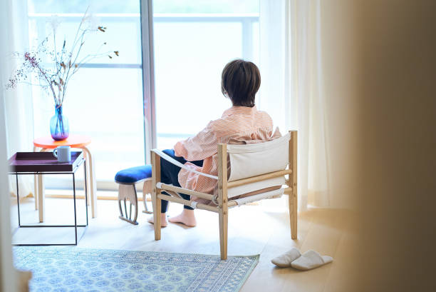 istock Woman relaxing by the window 1477909845