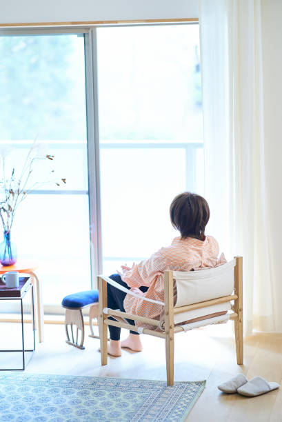 istock Woman relaxing by the window 1477909948